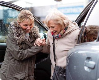 M8 helping woman out of car